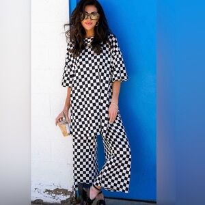 Dressed in Lala Lex Ribbed Playsuit in Black + White Checkerboard